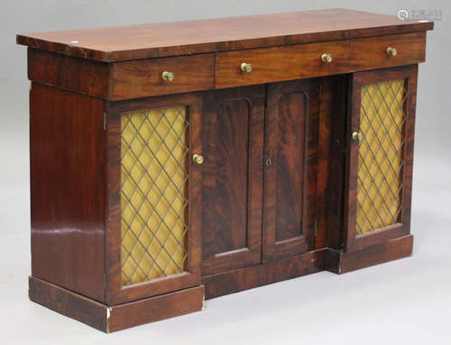 A Victorian flame mahogany side cabinet, fitted with three drawers above a pair of panelled doors,