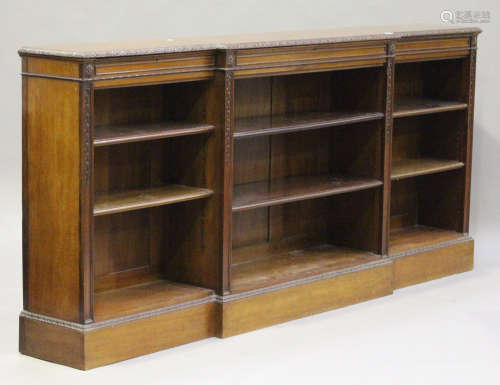 An early 20th century Neoclassical Revival mahogany breakfront open bookcase with carved decoration,