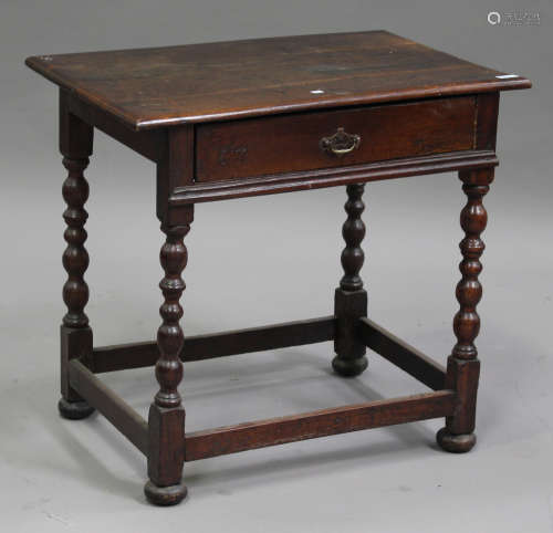 An 18th century oak side table, fitted with a single frieze drawer, raised on turned and block