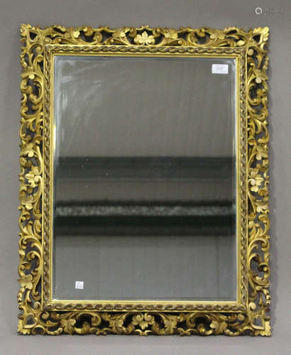 A 19th century Florentine giltwood rectangular wall mirror with pierced foliate scroll frame, 77cm x