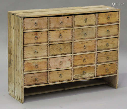 An early 20th century stripped pine bank of twenty drawers with ring-pull handles, height 76cm,