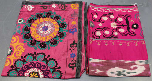 A 20th century Turkish suzani, the pink silk ground with a border of embroidered flowers and