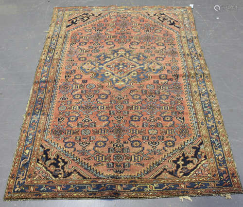 A Hamadan rug, North-west Persia, early 20th century, the pale pink field with a shaped medallion,