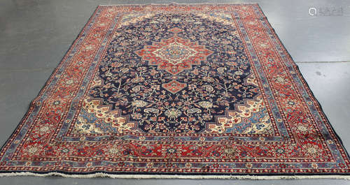 A Tabriz carpet, Central Persia, late 20th century, the ink blue field with an angular medallion,