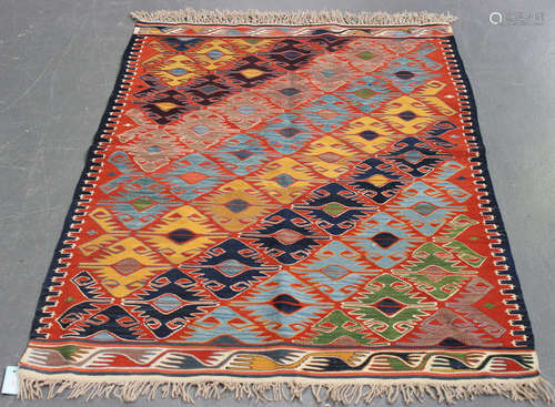 A Turkish kelhim rug, late 20th century, the terracotta field with overall diagonal polychrome