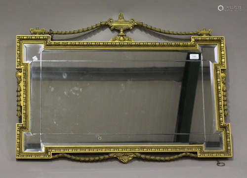 A mid/late 20th century giltwood wall mirror, the shaped frame with urn and swag surmount, 68cm x