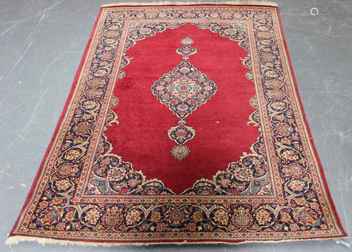 A Kerman rug, Central Persia, early 20th century, the claret field with a shaped medallion, within