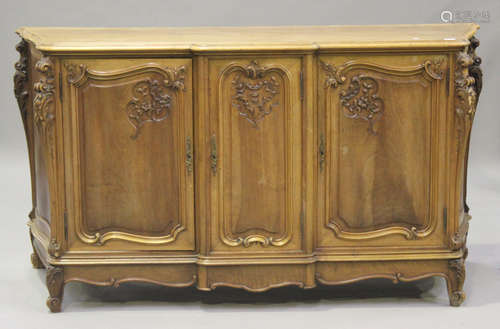 An early 20th century French walnut sideboard with carved scroll decoration, the moulded top above