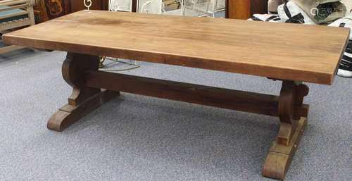 A large 20th century chestnut farmhouse refectory style table, the rectangular top on shaped lyre