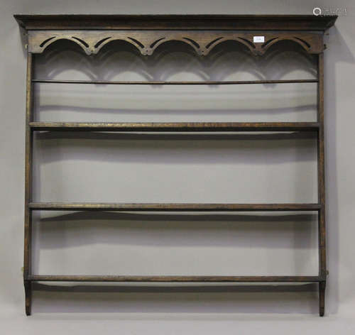 A George III provincial oak hanging plate rack with a moulded pediment and pierced frieze, height