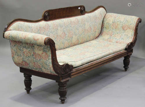 A Regency mahogany framed scroll arm settee with carved acanthus leaf decoration, on turned and