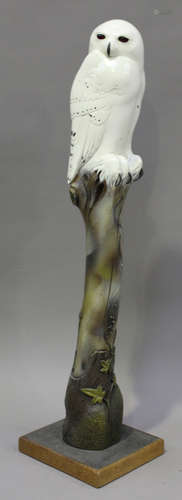 Raymond John Coutu - a late 20th century painted and carved wooden model of a snowy owl on a