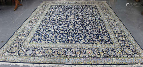 A Kashan carpet, Central Persia, late 20th century, the midnight blue field with overall scrolling