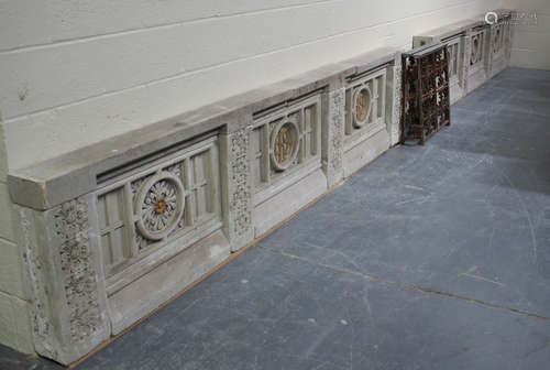 A mid-20th century ecclesiastical carved stone altar rail wall of section form, centred by a wrought