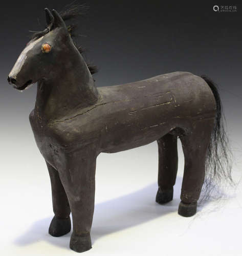 A 20th century folk art painted wooden model of a horse, height 50cm.Buyer’s Premium 29.4% (