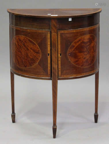 A George III mahogany and satinwood inlaid demi-lune side cabinet, fitted with a cupboard, on square