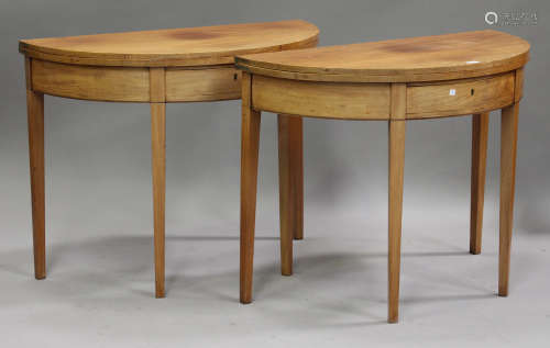 A pair of George III mahogany demi-lune fold-over tea tables with boxwood stringing, the hinged tops