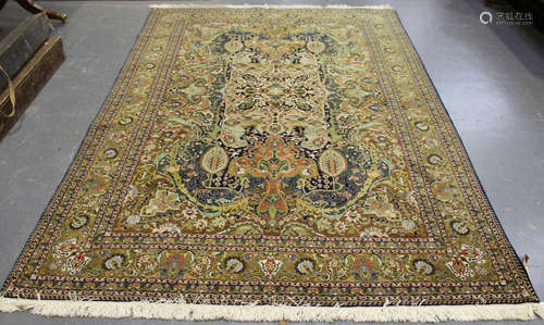 A Tabriz carpet, Central Persia, mid/late 20th century, the olive green field with a large shaped