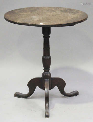 A Victorian oak circular tip-top wine table, on a turned column and tripod cabriole legs, height