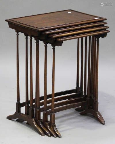 A 20th century mahogany quartetto nest of occasional tables, raised on turned legs and bracket feet,