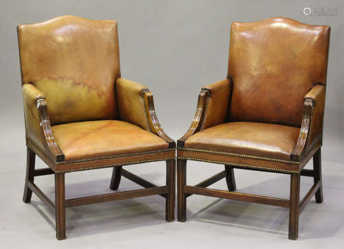 A pair of 20th century George III style mahogany framed and tan leather upholstered armchairs with