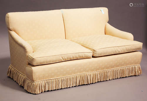 A modern Howard & Sons style two-seat sofa, the scroll arms and back upholstered in cream