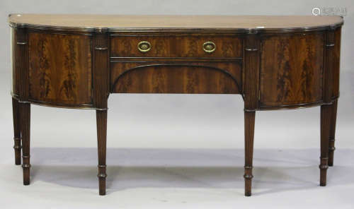 A 20th century reproduction mahogany bowfront sideboard by Maple & Co, fitted with drawers and