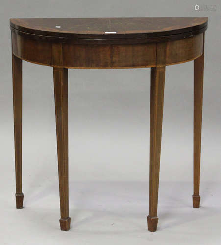 A late 19th century mahogany and amboyna inlaid demi-lune fold-over card table, raised on square