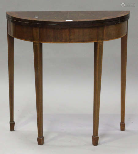 A late 19th century mahogany and amboyna inlaid demi-lune fold-over card table, raised on square