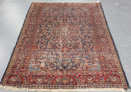 A Kashan rug, Central Persia, early 20th century, the dark blue field with a shaped medallion,