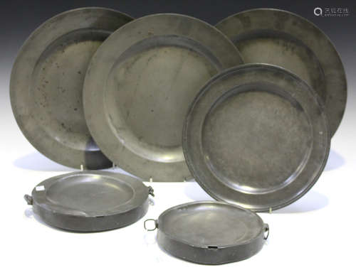 A small group of pewter, comprising a set of three 19th century chargers, diameter 38cm, a plate and