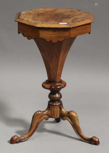 A late Victorian walnut octagonal work table of tapering form, the hinged lid enclosing a fitted