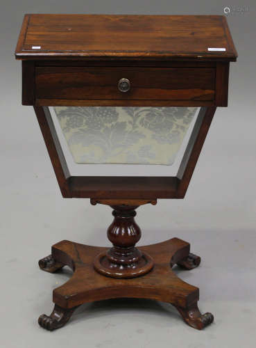 A 19th century rosewood work table, the moulded top above a drawer and a well, on a turned column,