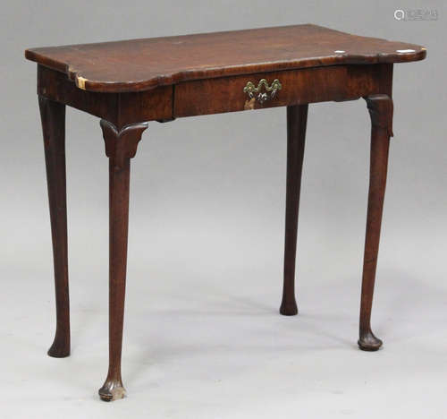 A George II walnut side table with projecting corners, fitted with a drawer, raised on turned legs