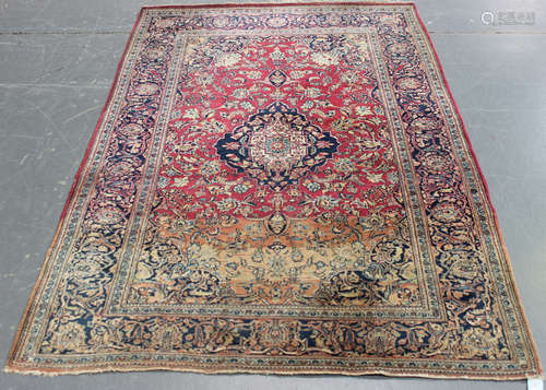 A Kashan rug, Central Persia, early 20th century, the claret field with a shaped medallion,