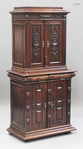 A late 19th century Continental walnut side cabinet, fitted with four carved and panelled doors, the