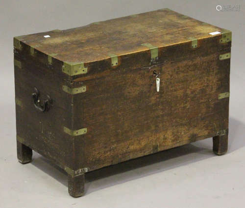 A 19th century teak and brass bound chest, on block legs, height 49cm, width 69cm, depth 40cm.