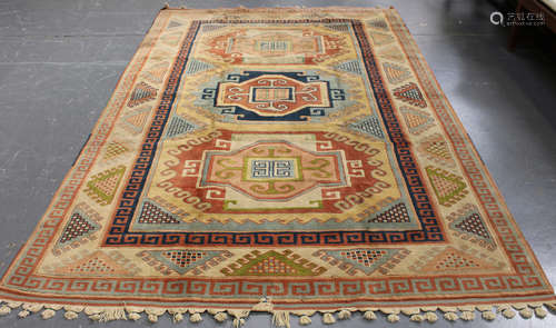 A Turkish carpet, late 20th century, the field with three bold polychrome medallions, within an