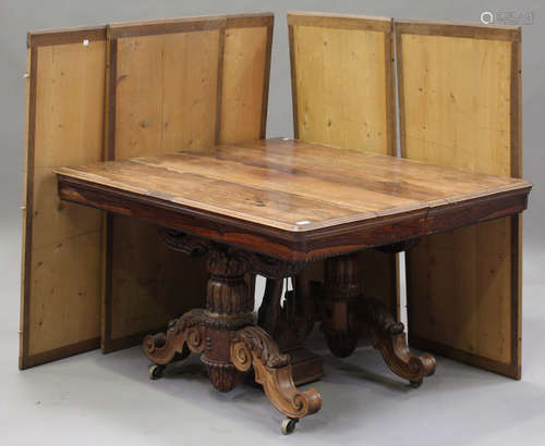 A mid-19th century French rosewood extending dining table with five extra leaves, the moulded top