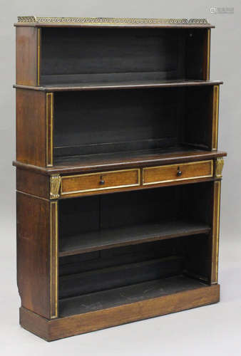 A Regency rosewood open bookcase with gilded decoration, fitted with two central drawers, on a