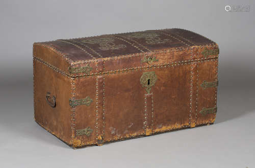 An 18th century brown leather and brass studded trunk, the hinged lid with two studwork crowned 'AR'