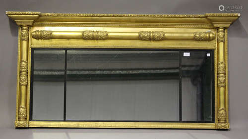 A Regency gilt painted overmantel mirror, the inverted breakfront above a three-section mirror, 75cm