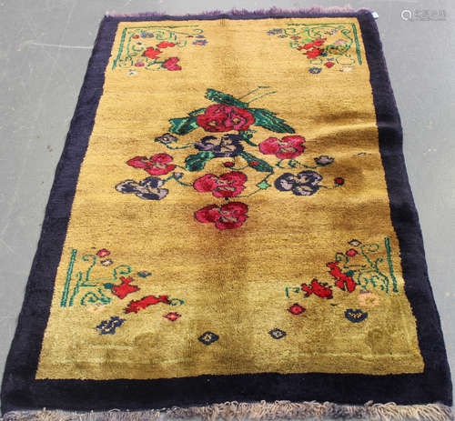 A Turkish rug, mid-20th century, the mustard yellow field with sparse rose sprays, within a plain