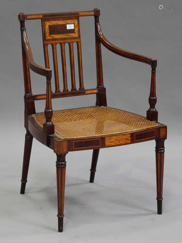 An Edwardian mahogany and satinwood banded elbow armchair, the pierced rail back above a caned seat,