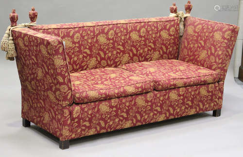 A late 20th century Knole settee, upholstered in woven foliate claret fabric, on block legs,