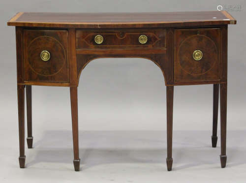 A late George III mahogany and satinwood banded bowfront sideboard, fitted with three drawers, on