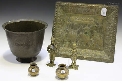 A small group of Eastern brassware, including two deity figures and a rectangular tray, decorated