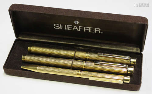 A group of three Sheaffer gold plated pens, comprising two fountain pens with 14k gold nibs and a