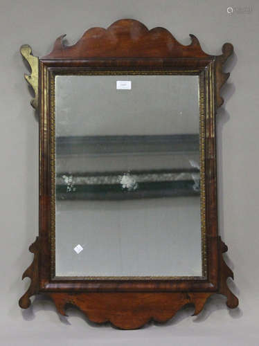 A 19th century George III style mahogany fretwork framed wall mirror, the figured cushion section