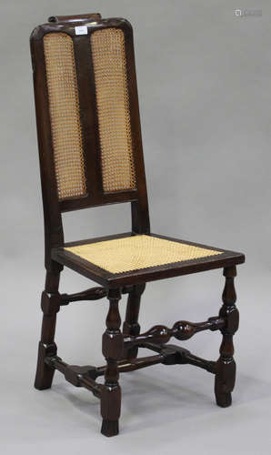 A William and Mary walnut side chair with cane seat and back, raised on turned and block legs united